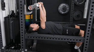 BarBend's Jake Herod performing the flat bench press exercise.