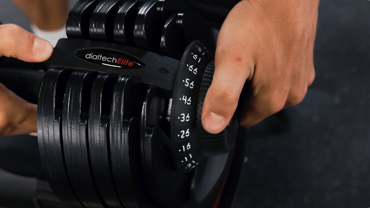 BarBend's Jake Herod adjusting the Ativafit Adjustable Dumbbells.