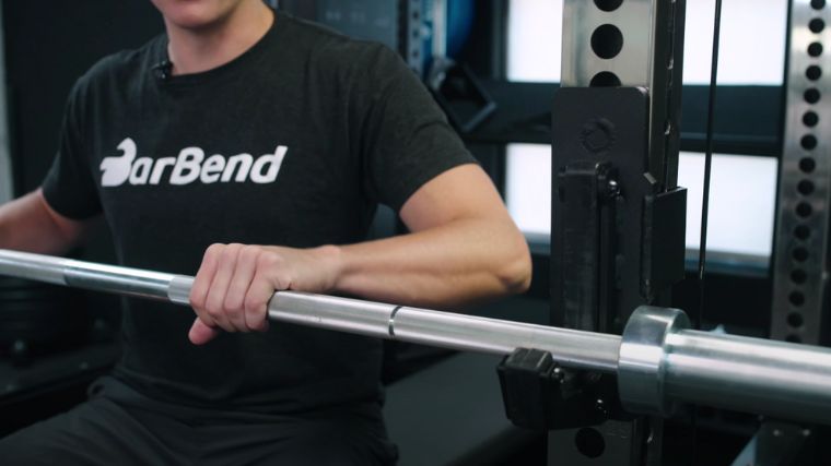 Our tester gripping a barbell where the knurling is.