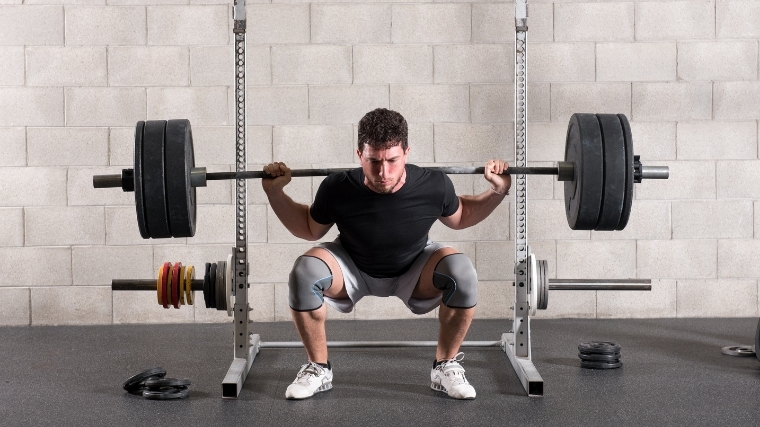 Man squatting a barbell