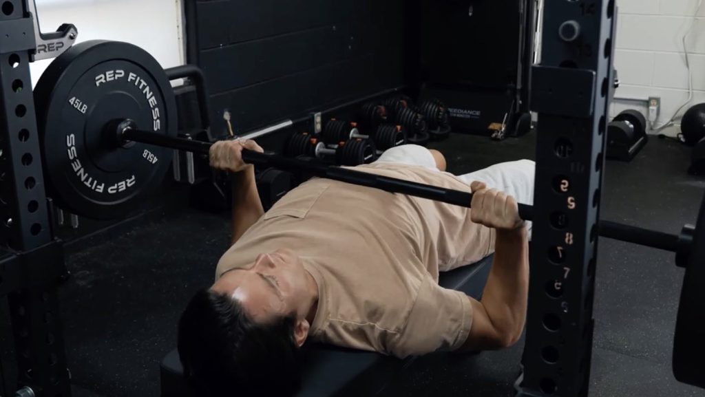 Our tester bench pressing with the REP Fitness Double Black Diamond Power Bar.