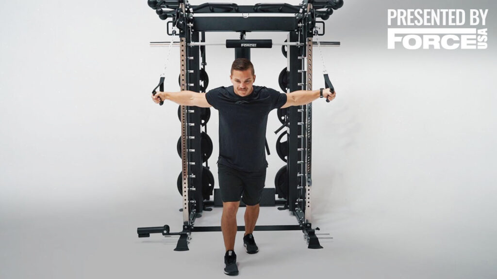 A man working out on a cable machine.