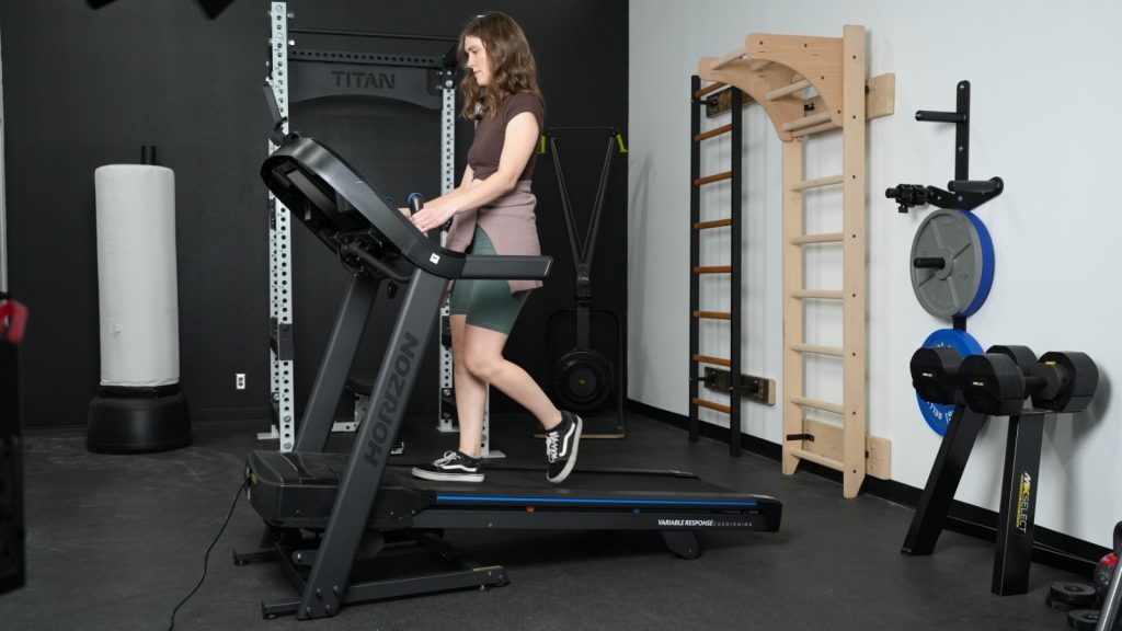 A woman is shown walking on Horizon 7.0AT treadmill.