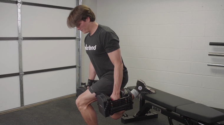 BarBend's Jake Herod performing the split squats with the Powerblock Pro 50 Adjustable Dumbbells.