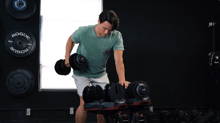 BarBend's Jake Herod rows with the Ativafit Adjustable Dumbbells.