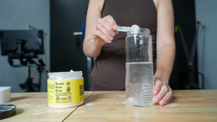 Our tester mixing a scoop of Naked Nutrition Naked Energy.