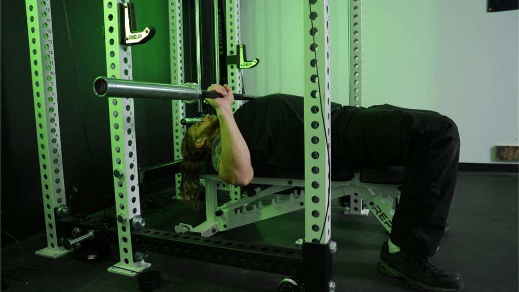 BarBend tester using REP Fitness bench for bench press.