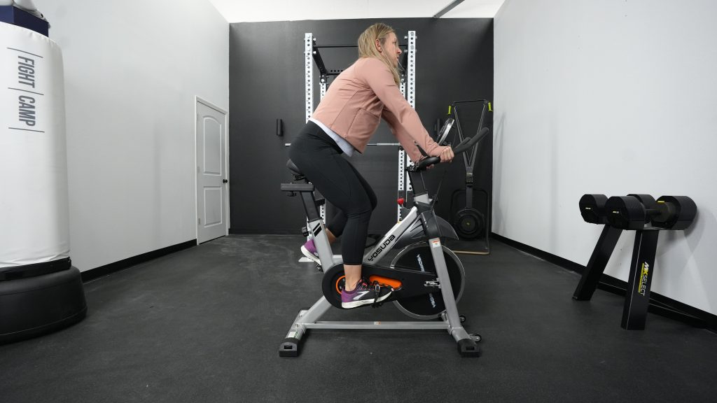 A woman riding a Yosuda YB001R exercise bike