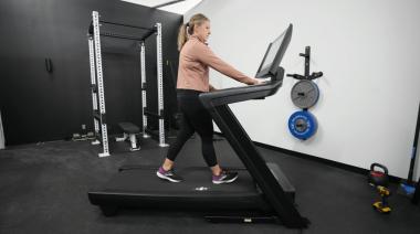 Our tester on one of the Best Treadmills at Best Buy.