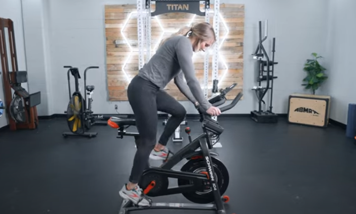 A person riding a Schwinn IC4 exercise bike